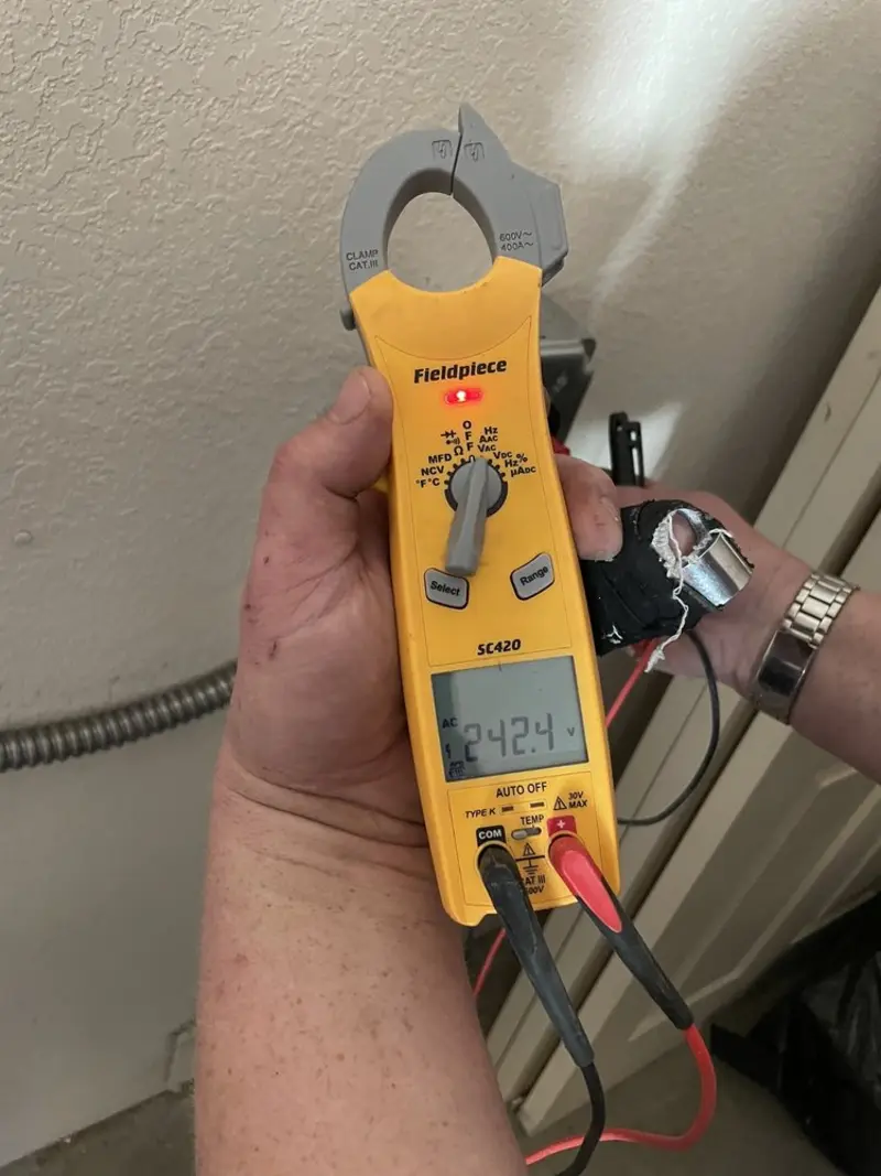 Voltage testing with clamp meter during Electrical Installation Services in Keyes